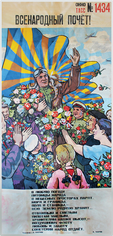 Parachuting pilot covered in flowers is greeted on the ground by smiling people; blue,yellow, pink