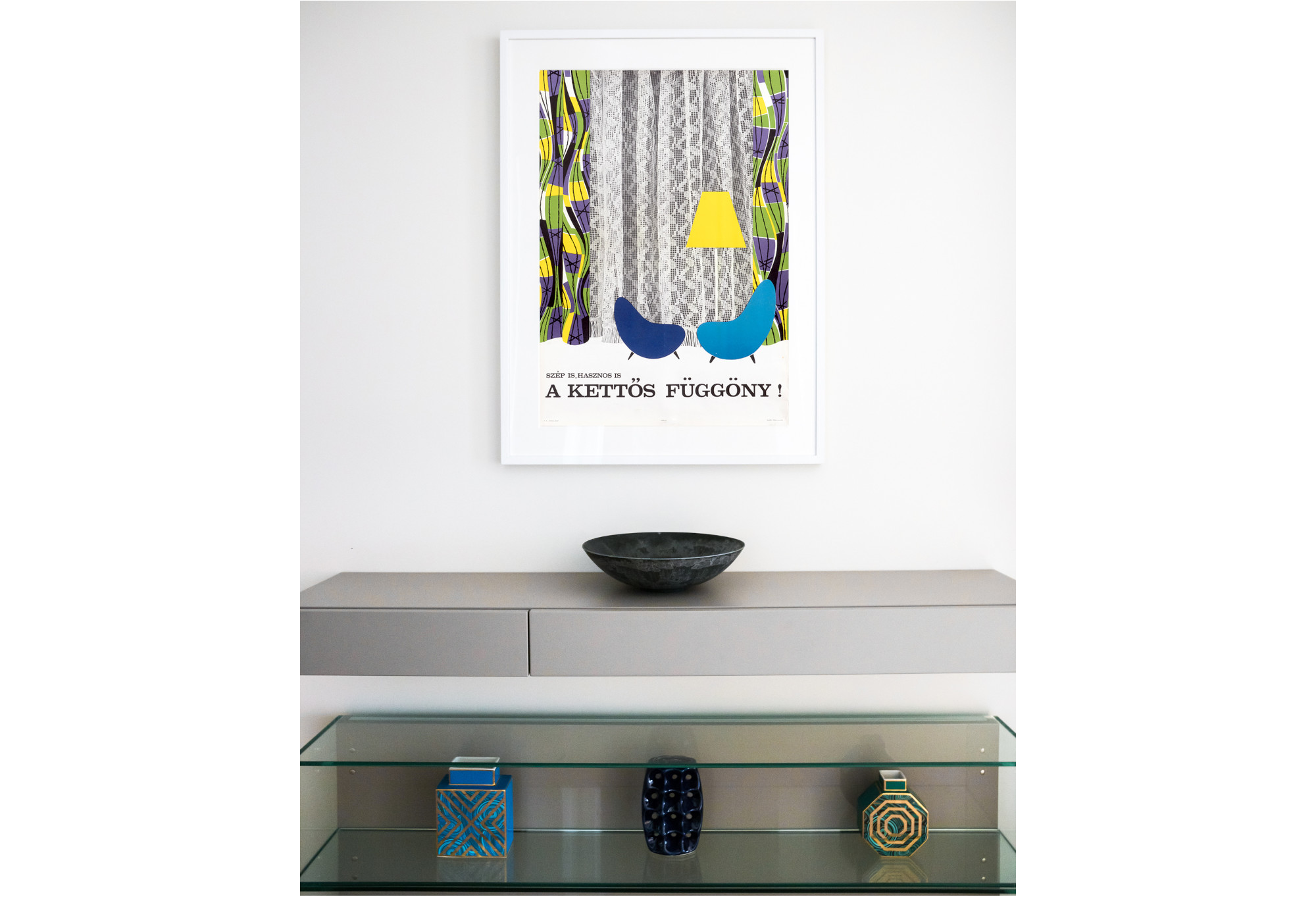 photograph of mid-century modern poster featuring chairs and curtain above decorative bowls and vases; white, grey, blue, purple, yellow, green